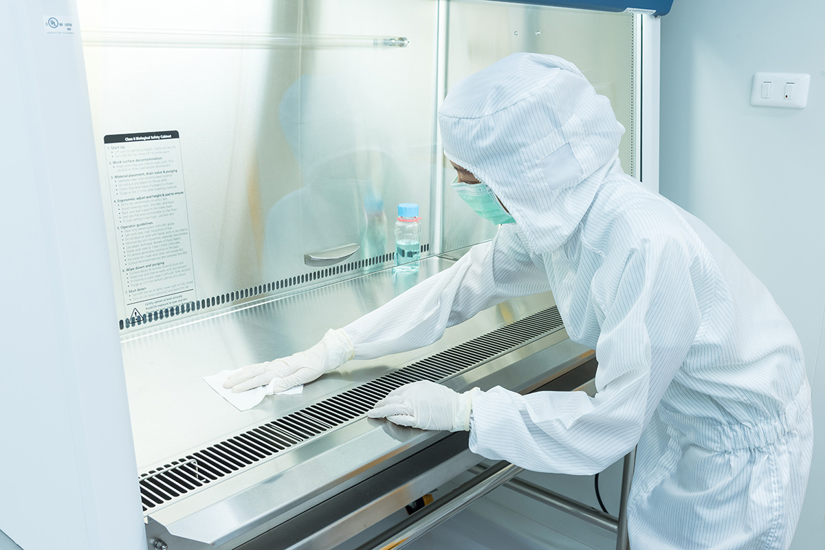 Photo of person cleaning a fume hood in a cleanroom