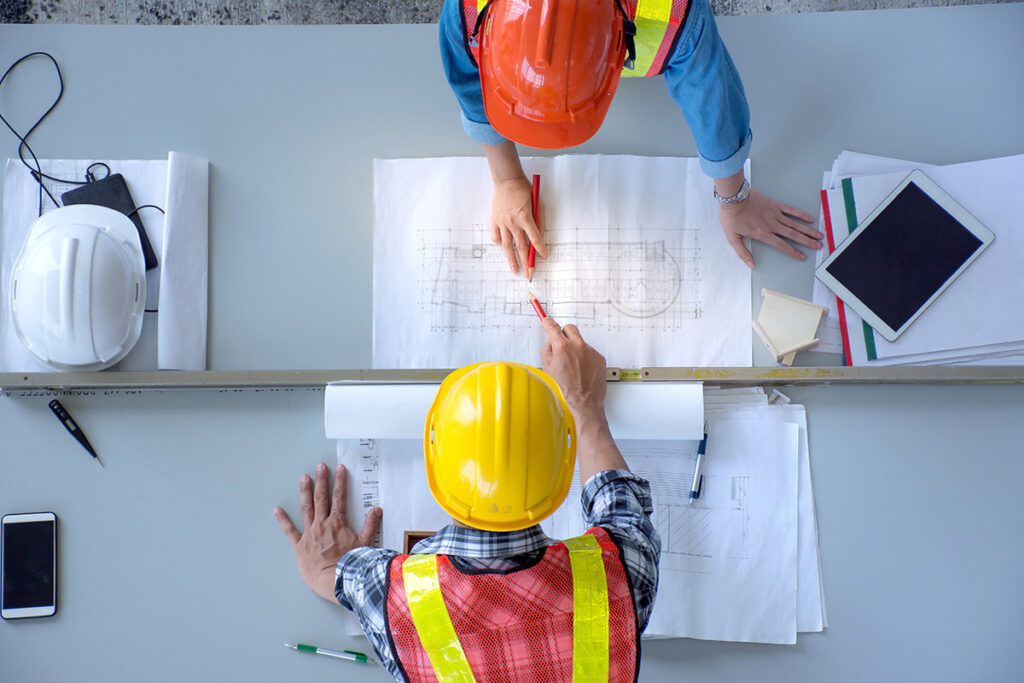 Photo of construction workers consulting plans